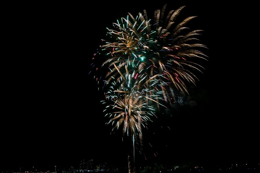 Fireworks over the water at night